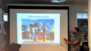 Dr. Charlie Rolsky presents a slide on the 2026 summer interns at the recent community updates event.