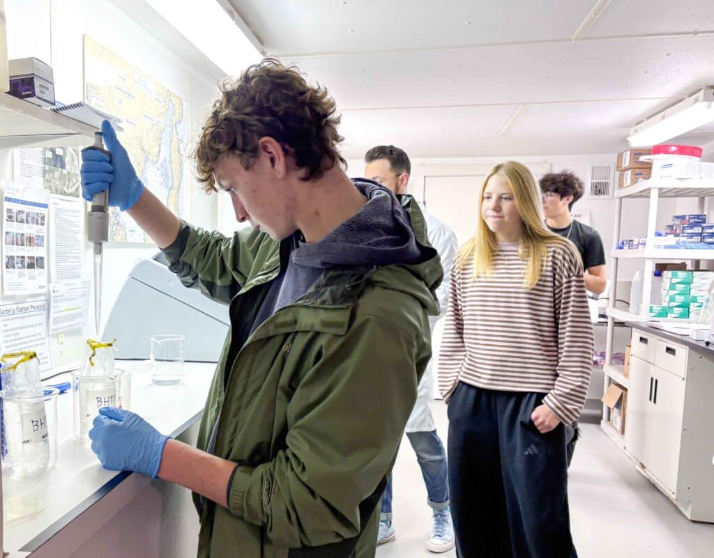 Student conducts a water test in Shaw Institute's lab.